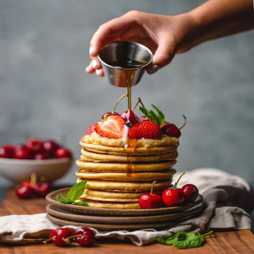 pancakes with strawberries syrup cherries hemp hearts